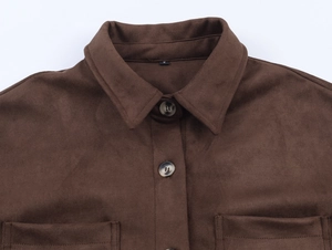 Detailed view of dark brown faux suede texture with stylish amber-patterned buttons