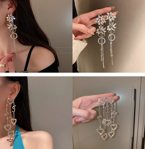 Detail showing u-shape pearl tassel earrings with rhinestones for elegant evening wear