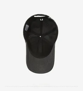 Detail view of the black baseball cap interior showing reinforced seams and brand label
