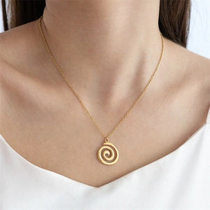 Modern gold necklace featuring a minimalist spiral swirl pendant on a delicate chain