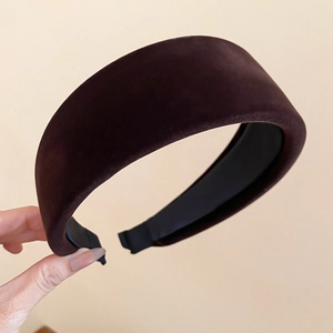 Close-up of thick dark brown flocked fabric headband with soft velvety texture detail