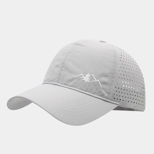 Detail view of laser-cut ventilation holes on a breathable quick-dry baseball cap