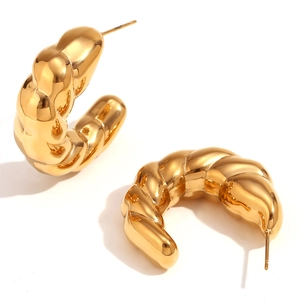 Polished 18K gold plated stainless steel croissant dome hoop earrings on white background