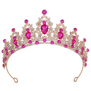 Detailed view of pink teardrop crystal crown with sparkling rhinestones on gold base