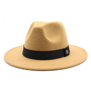 Detailed view of camel wool fedora hat with black ribbon and gold M metal emblem