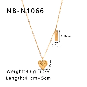 Detail of 18k gold plated heart pendant with engraved bar on a minimalist necklace