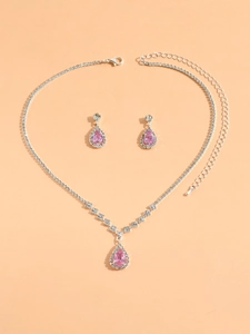 Detail of pink crystal teardrop necklace and earrings set with zircon accents in silver