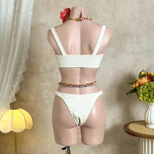 Rear view of white satin bikini with pleated swim bottoms and colorful beaded waist chains