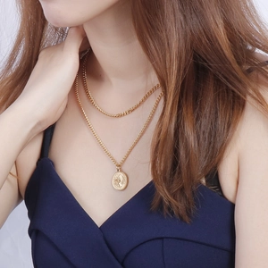 Layered gold-tone coin necklace featuring Queen Elizabeth II portrait and Cuban link chain