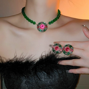 Vintage French style jewelry set with pink gemstones and green beads on a female model