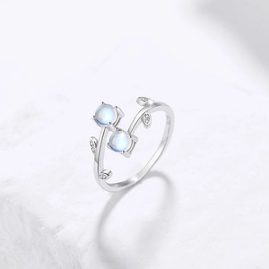 925 silver vine ring featuring light blue stones and cubic zirconia on white marble