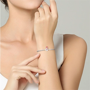 Silver snake chain bracelet featuring a colorful Christmas snowman enamel charm for women