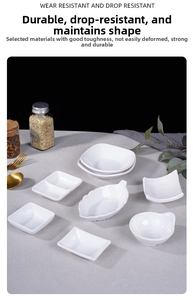 Detail of white melamine dipping dishes in various shapes on a textured grey cloth