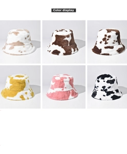 Detail display of cow print faux fur bucket hats in various soft plush color options