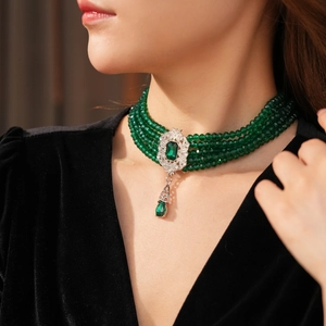 Detail shot of vintage emerald green multi-layer beaded choker worn on model