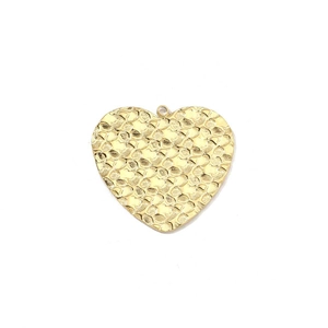 Detailed view of golden heart pendant with hammer-textured finish and polished metal shine