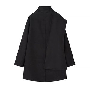 Detail of black wool coat featuring unique asymmetrical layered back design and premium fabric