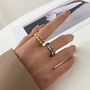 Detail of adjustable gold and silver fidget rings with spinning beads on model fingers