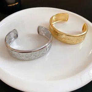 Vintage embossed oval open cuff bracelet in gold and silver finish with floral texture