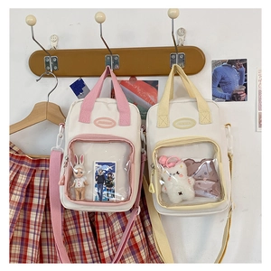 Detail of pink and yellow canvas ita bags with transparent PVC windows and JINNIAN label