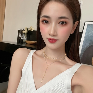 Elegant multi-layer gold necklace set with sparkling rhinestones and long tassel pendant