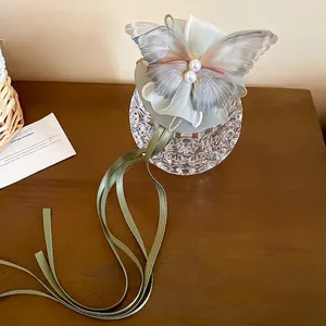 Elegant butterfly pearl hair claw with ribbons in a soft forest green aesthetic