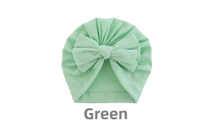 Detail view of mint green baby turban hat with a large bow made of soft elastic cotton