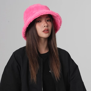 Close-up of pink fuzzy plush bucket hat showing soft texture and cozy winter fabric