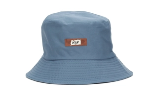 Detail view of grey-blue canvas sun hat featuring a stitched 1403 number patch