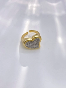 Macro view of gold plated heart ring with sparkling paved zircon stones and adjustable band