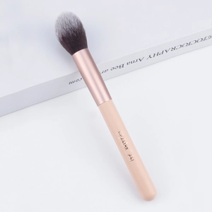 Close-up of soft black-white gradient bristles and rose gold ferrule on makeup brush