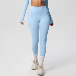 Detail of high-waist blue yoga leggings with seamless pockets and breathable fabric texture