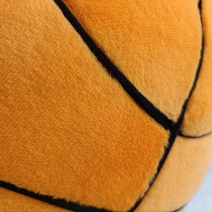 Macro shot of soft plush basketball pillow showing high-quality fiber texture