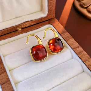 French vintage amber resin square earrings with gold hooks on a premium jewelry display