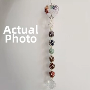 Detail of tree of life heart ornament with colorful stones and a crystal ball pendant