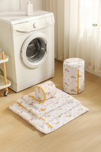 5-piece laundry wash bag set with cute bear print and yellow zippers in laundry room