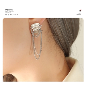 Close-up of silver tassel chain earrings in brass with asymmetrical fringe design