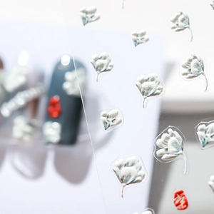 3D floral nail art stickers with white and red embossed flower patterns on clear sheet