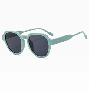 Detail view of mint green square sunglasses featuring thick frames and metal hinges