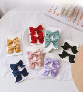 Detailed set of colorful satin bow hair clips for girls in various vibrant shades