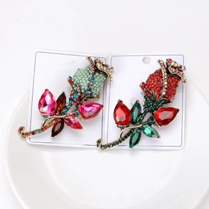 Detail of vintage rose brooches with rhinestones and colored crystals on display