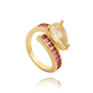 Detail of adjustable gold ring with red square zircons and a pear-shaped clear stone