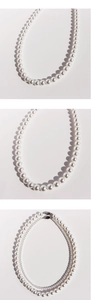 Detailed comparison of various sizes of lustrous white pearl necklaces on a white surface