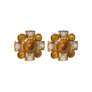 Vintage gold flower earrings with cat-eye stone and white pearls on white background