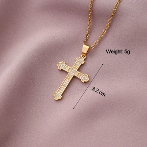 Macro view of gold-plated cross pendant with inlaid zircons and size measurements