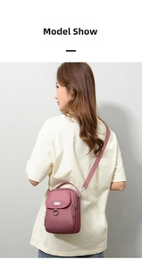 Detail of mauve nylon crossbody bag featuring multi-zipper layers and metallic hardware