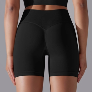 Detail of high waisted black gym shorts featuring a V-shaped back seam for butt lifting