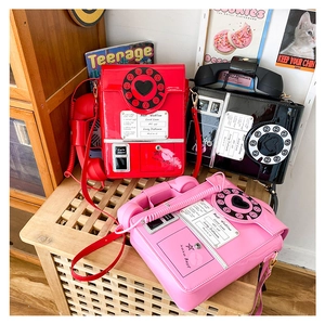 Retro telephone crossbody bags in red, black, and pink with glossy PU leather finish