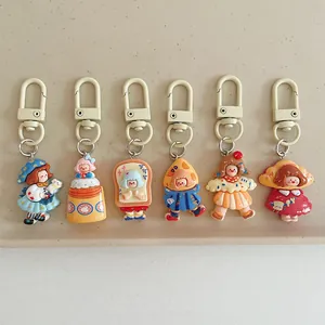 Detailed set of six cute cartoon girl resin keychains with colorful outfits and hooks