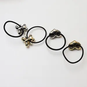 Metallic heart and star hair ties set in gold and silver finish on black elastic bands